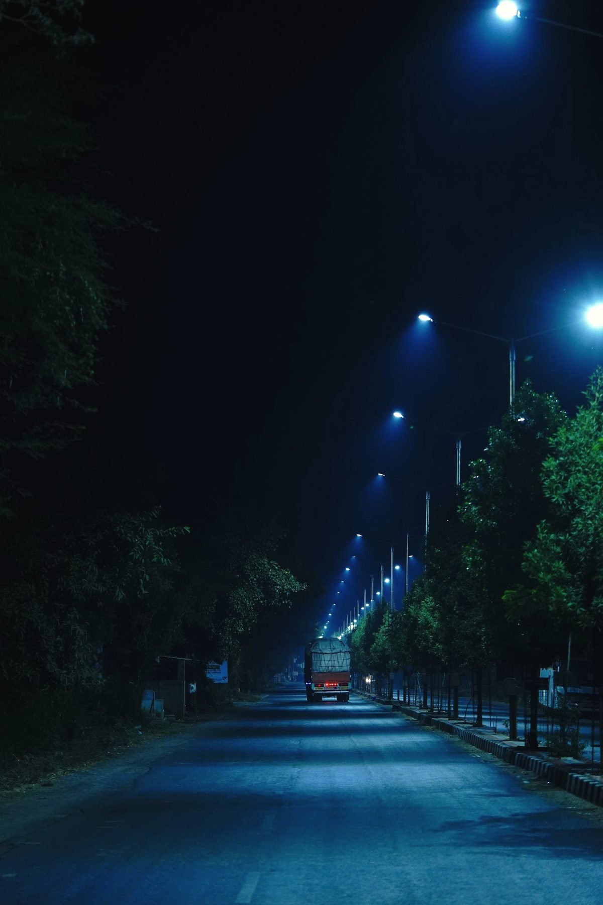 An empty street at night under streetlights